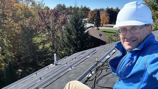 Paul on the roof installing rail mounting system from Iron Ridge